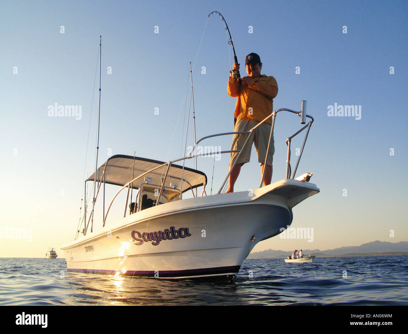Man fishing off bow of boat for tuna in Baja, Mexico Stock Photo