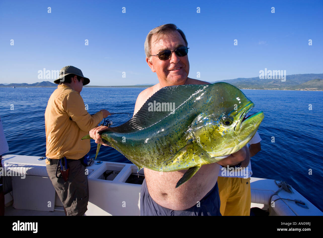 Man holding freshly caught mahi mahi fish off the coast of Baja
