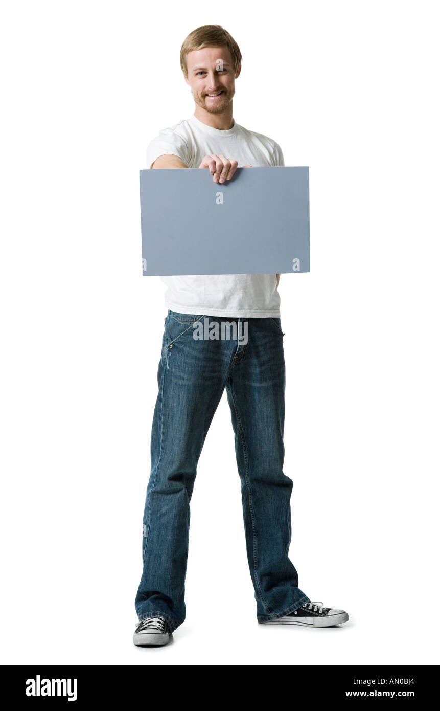 Portrait of a young man holding a blank sign Stock Photo - Alamy