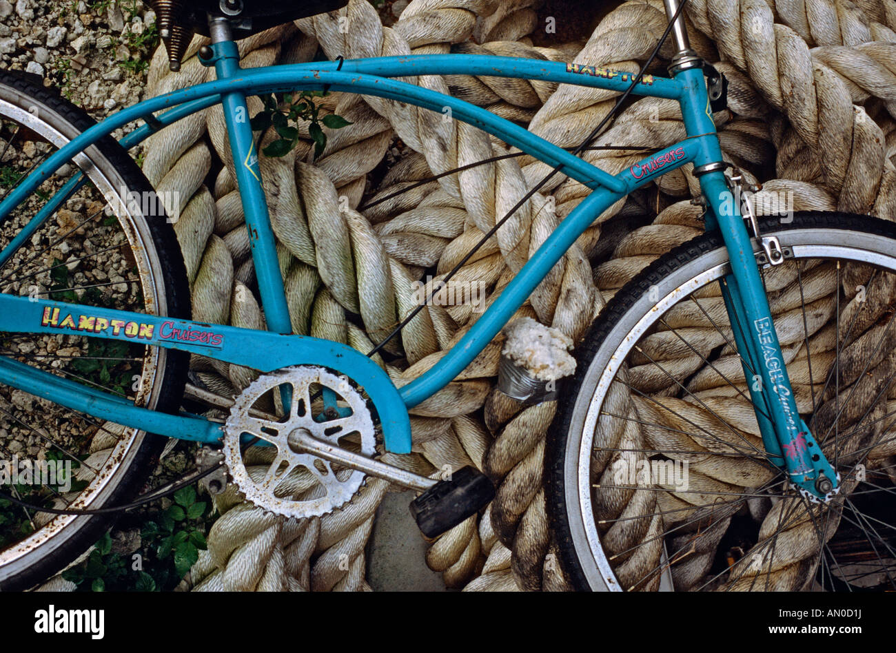 Bicycle leaning against pile of rope at a boatyard in Everglades City Florida USA Stock Photo