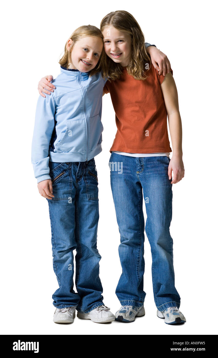 Portrait of two sisters standing with their arms around each other ...