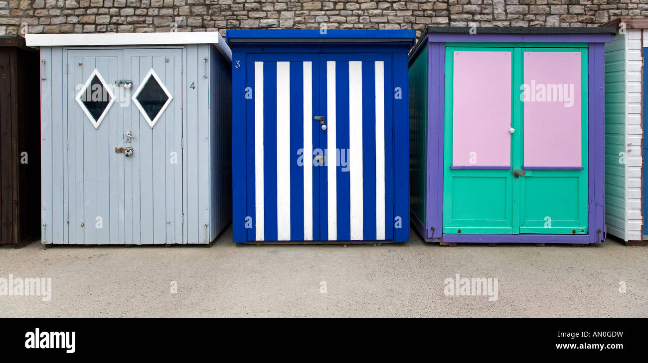 Beach huts painted in pastel colours situated on the promenade at Lyme Regis Dorset Stock Photo