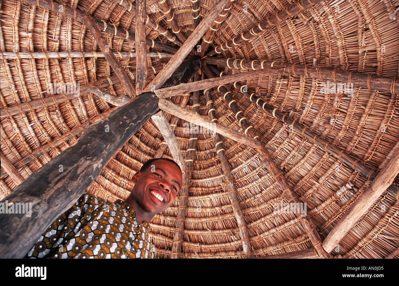 Friendly Mafia islander Pole Pole Lodge eco resort Under a thatch parasol Mafia Indian Ocean Tanzania East Africa Stock Photo
