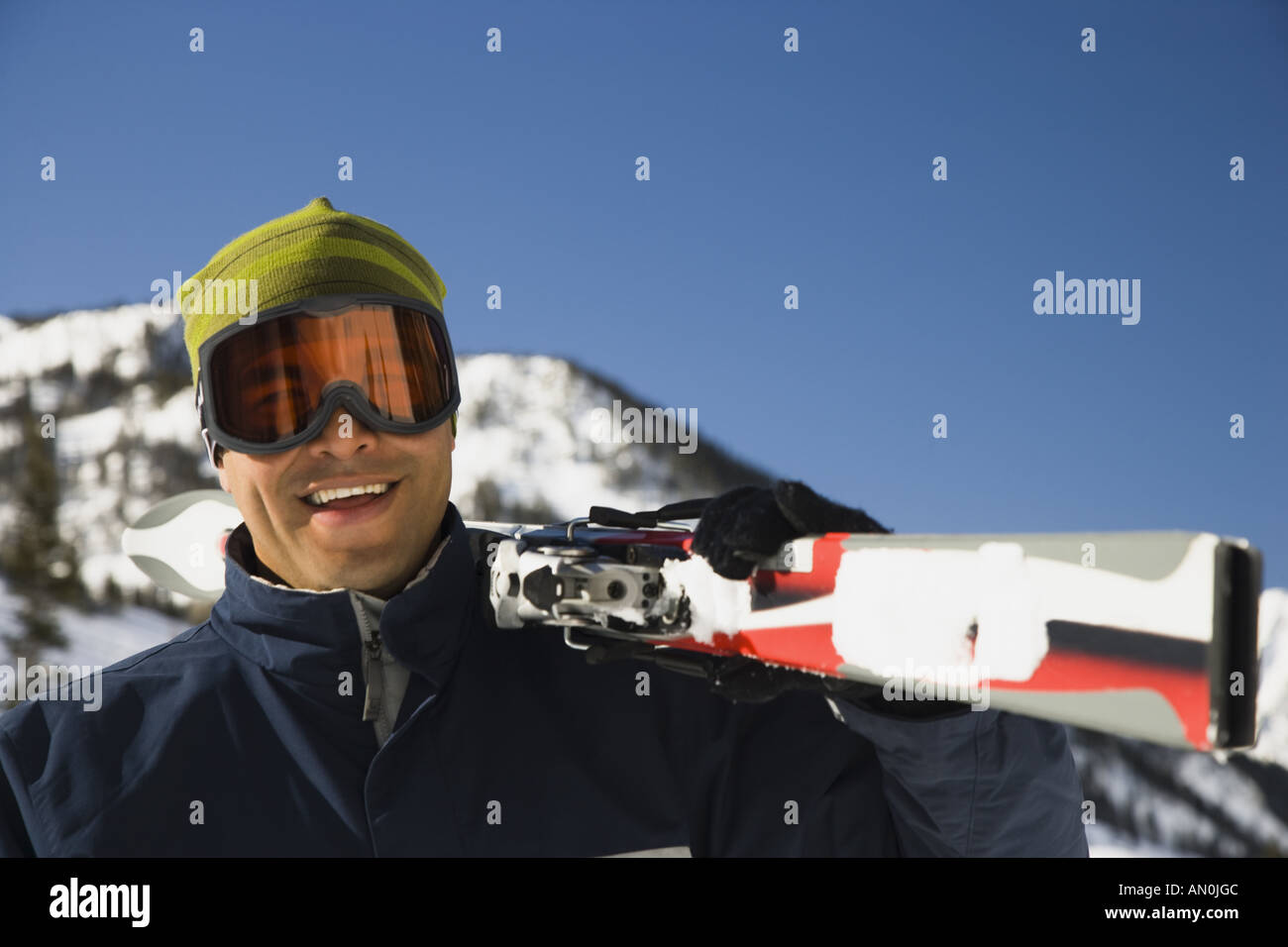 Portrait of an adult man carrying a ski on his shoulder Stock Photo - Alamy