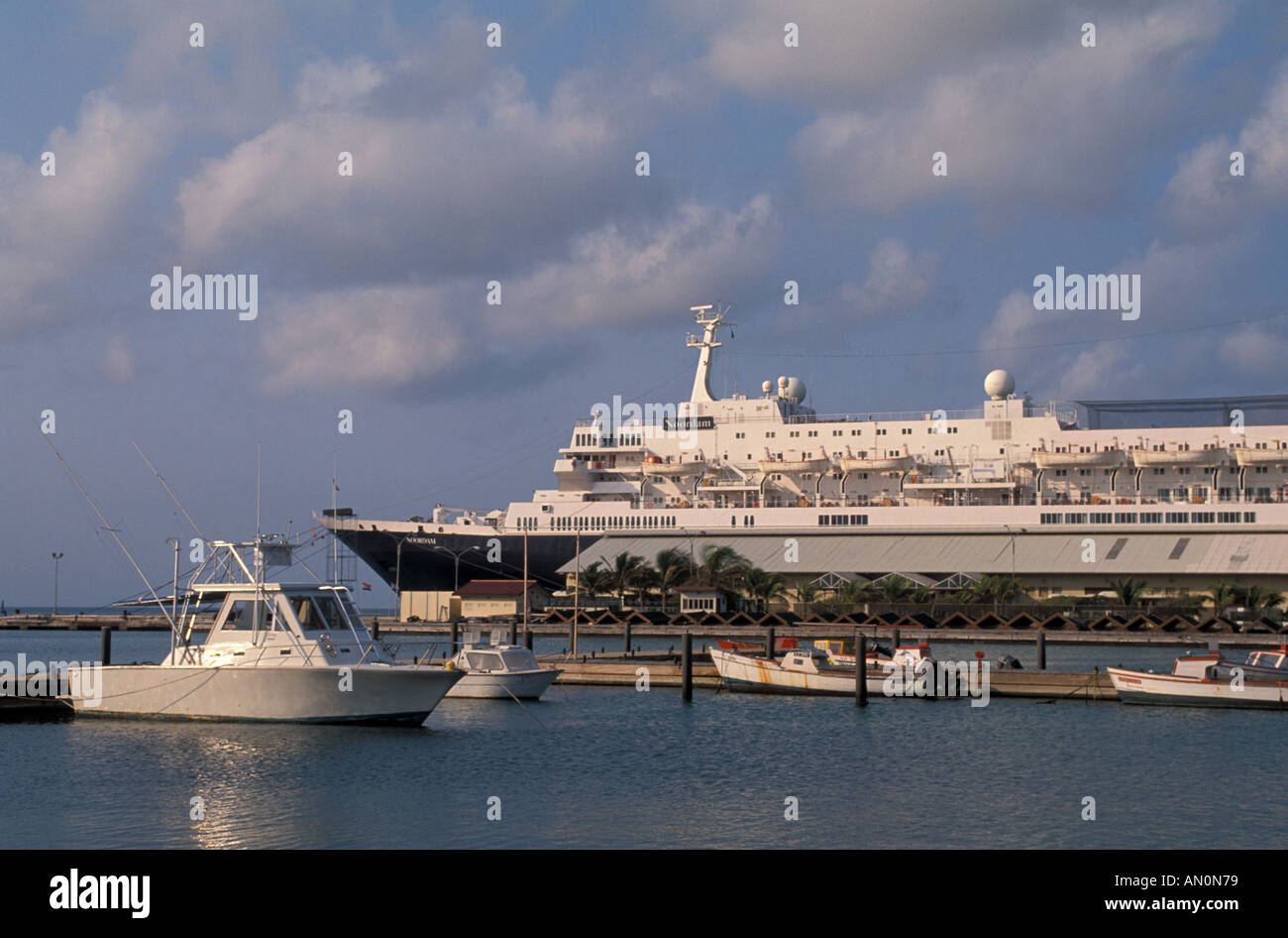 Cruise Ship docked in Oranjestad Aruba small local fishing boats in the foreground Stock Photo