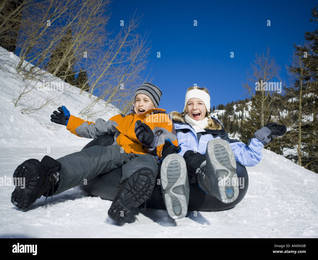 Two children sledding down hill hires stock photography and images Alamy