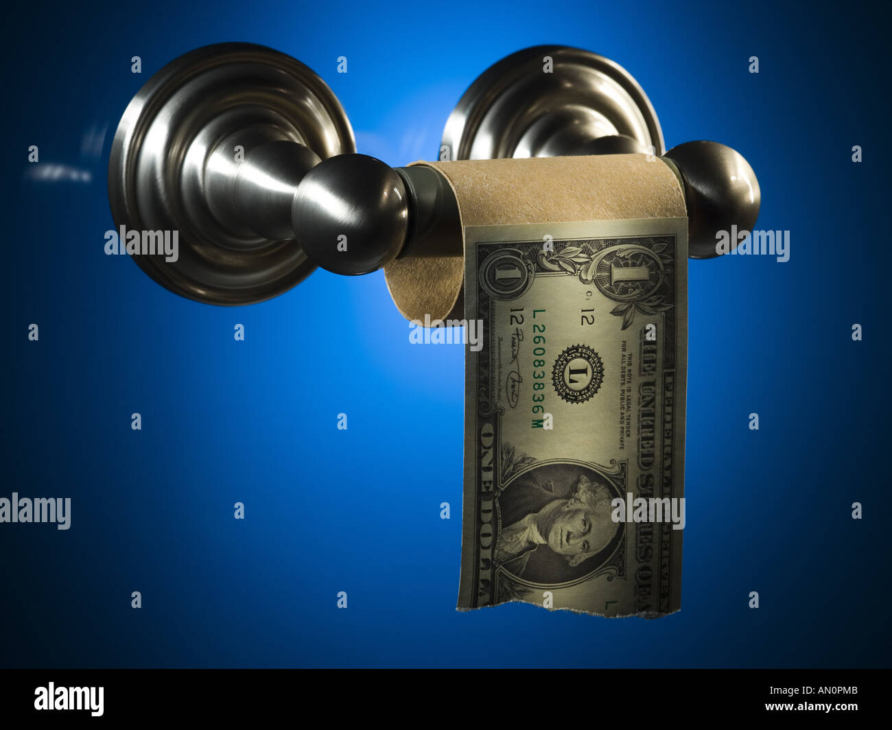 Close up of an empty toilet paper roll with a torn dollar bill Stock