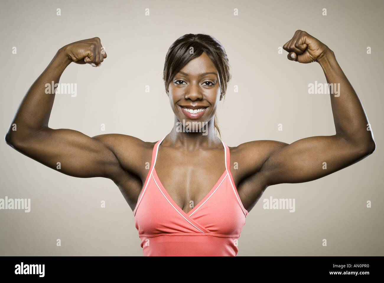 Hispanic woman flexing biceps hi-res stock photography and images - Alamy