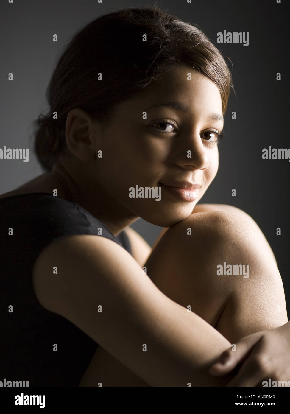 Portrait of a girl hugging her knees Stock Photo - Alamy