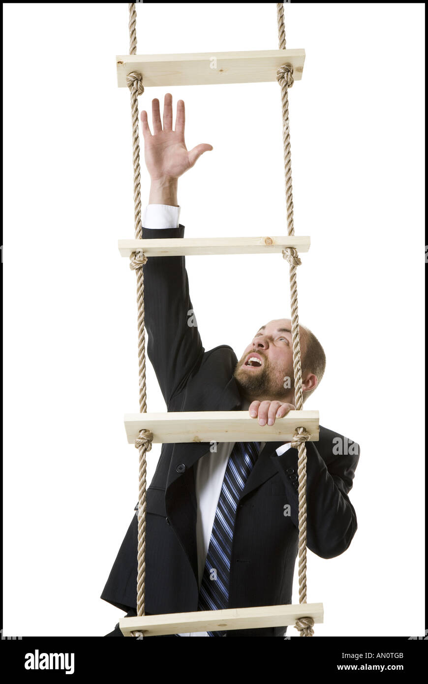 Close up of a businessman climbing a ladder Stock Photo