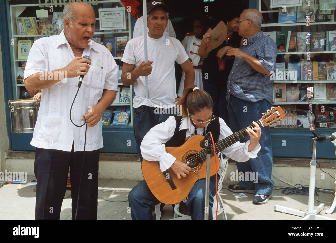 Woman playing the guitar to accompany male singer performing in the street Havana, Cuba. Stock Photo