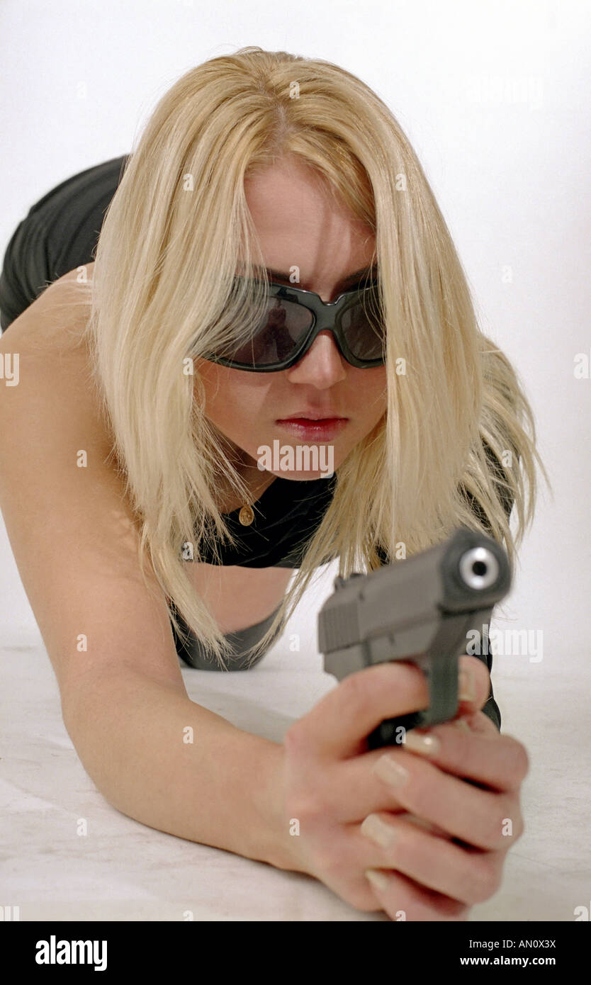 strong woman with black gun Stock Photo