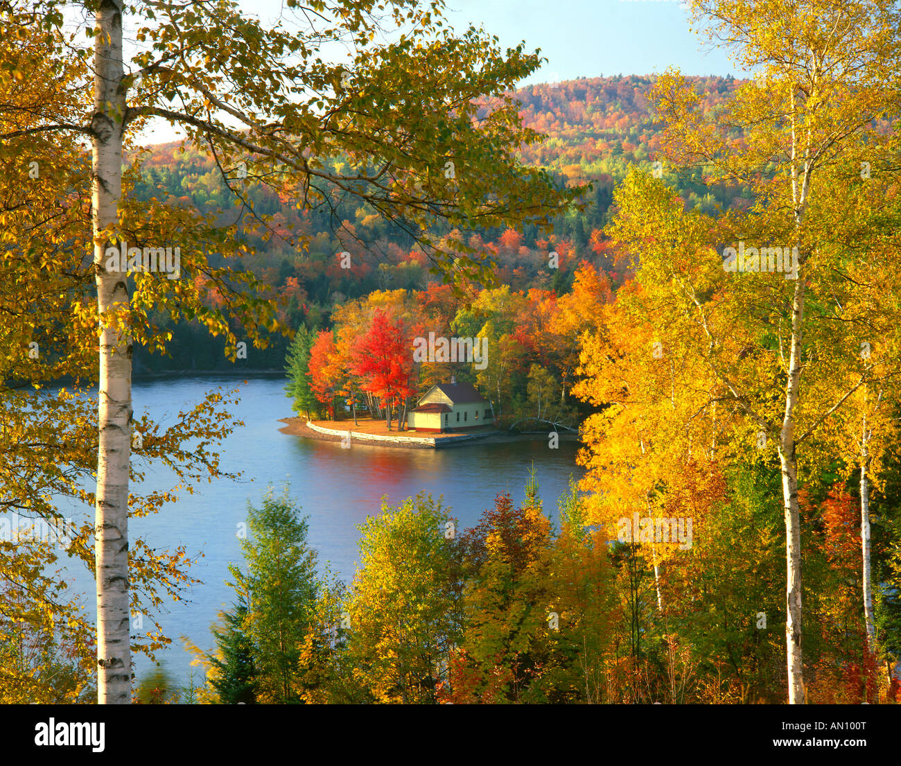 USA, Maine, Wyman Lake, Summer home on point surrounded by fall colors