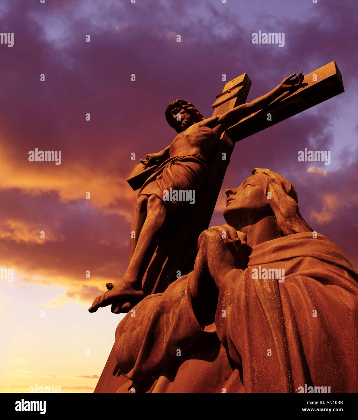 Statue of Jesus Christ on Cross at Sunset Stock Photo