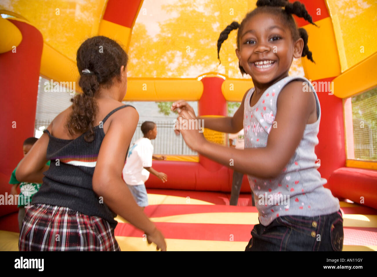 Children play in jump house at union picnic Stock Photo