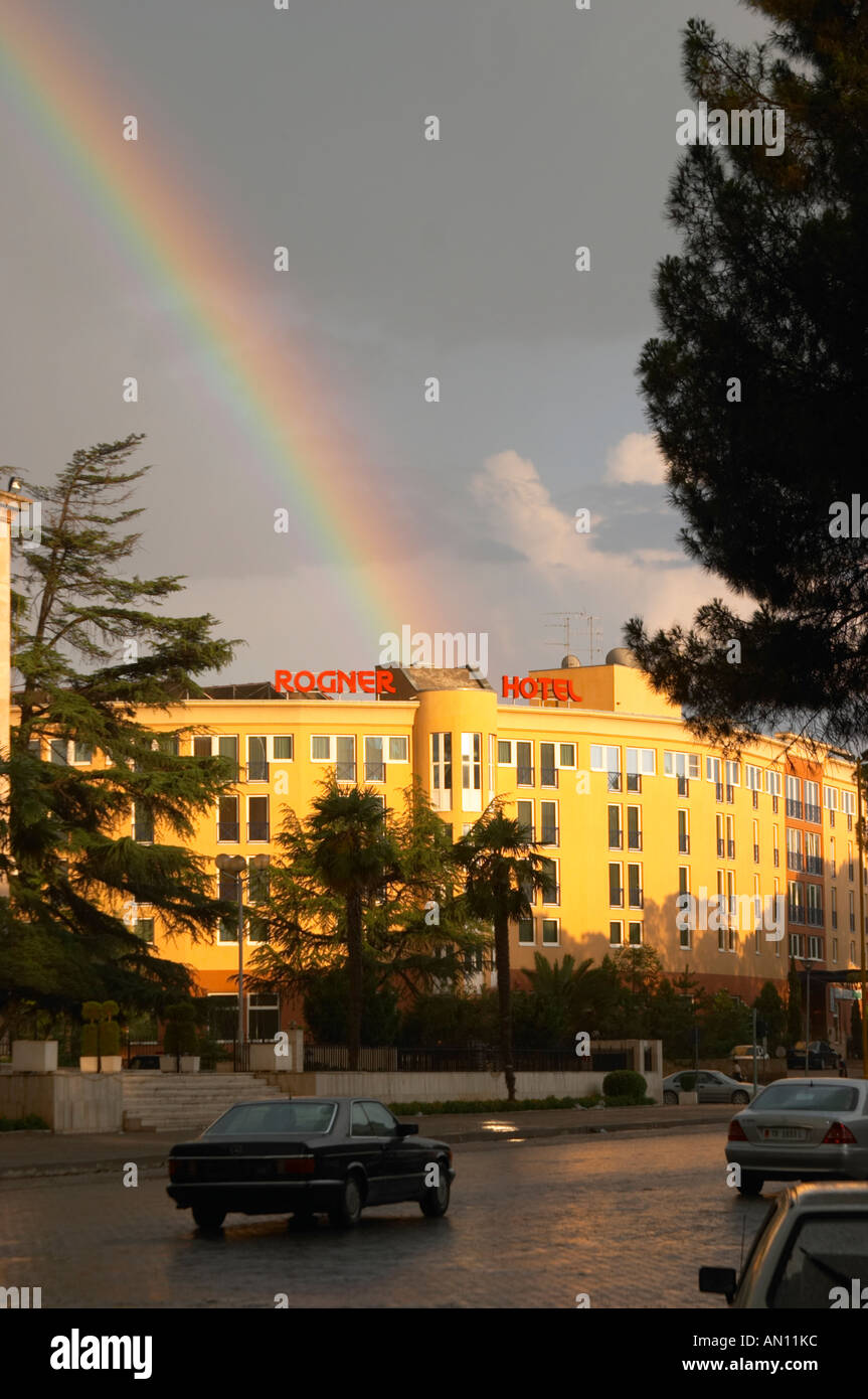 The Rogner Hotel in sunshine with a rainbow in the sky. On the Boulevard Bulevardi Deshmoret e Kombit. Tirana capital. Albania, Stock Photo