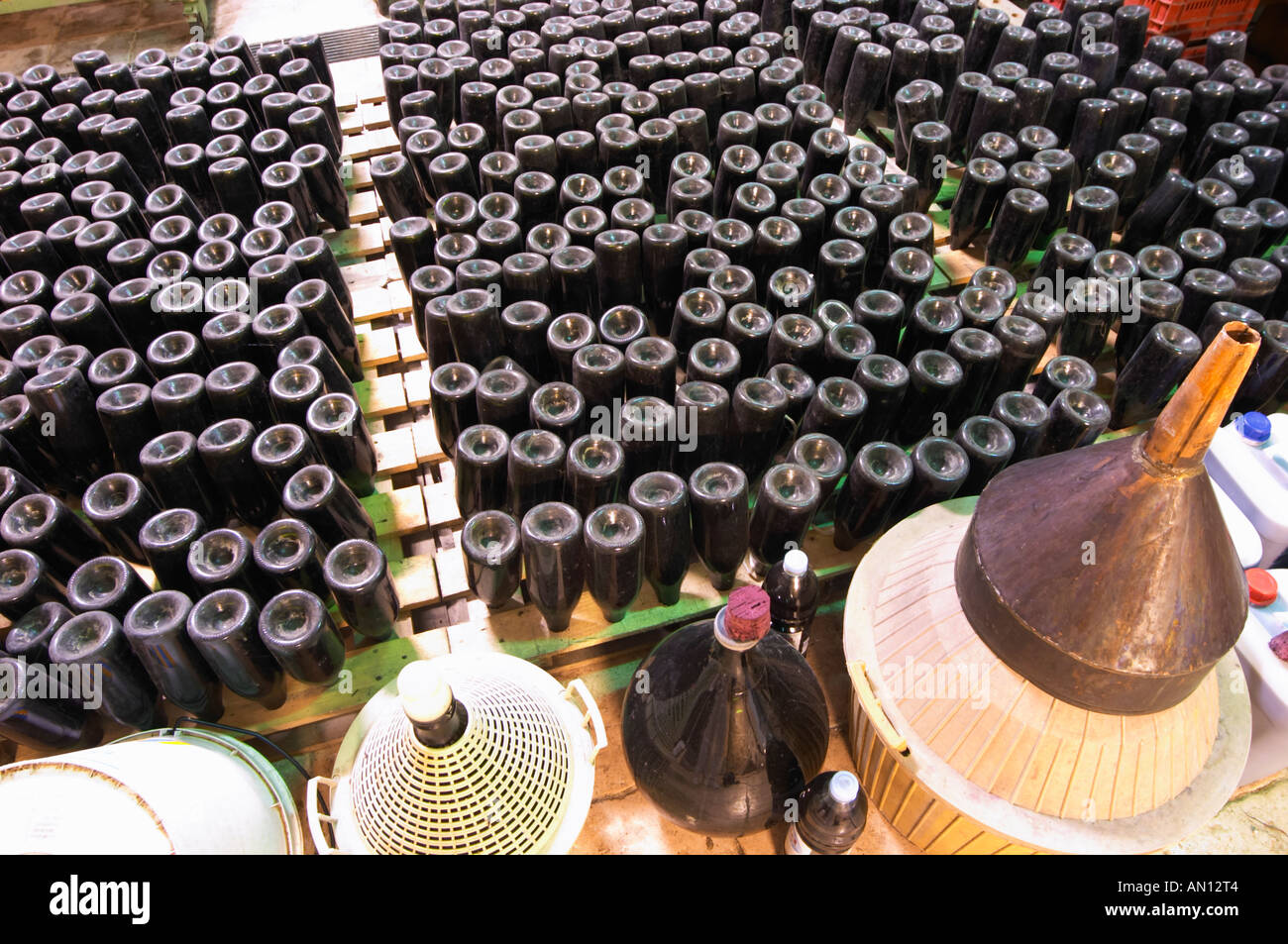 Bottles for sparkling wine standing upside down in a sort of pupitres