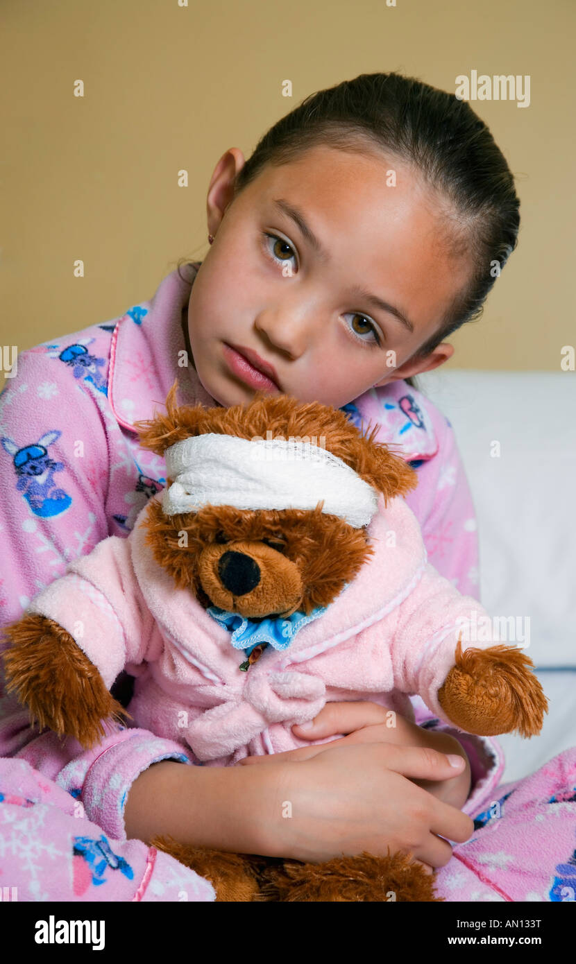 Little girl holding teddy bear Stock Photo