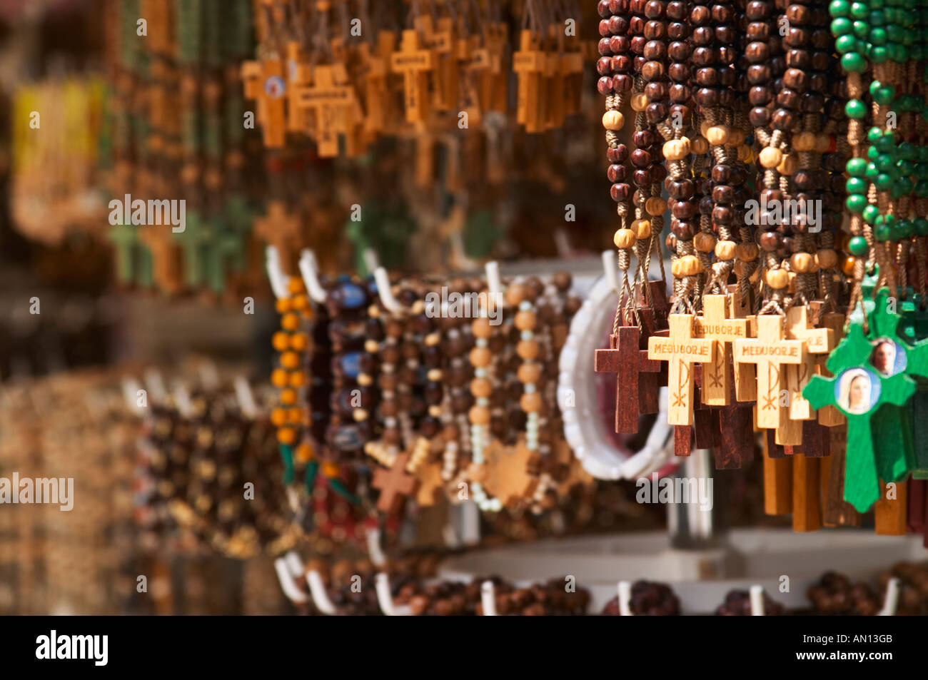 A shop with souvenirs for pilgrims, with things for sale. Rosary beads, with crosses with the name Medugorje on. Medugorje pilgrimage village, near Mostar. Medjugorje. Federation Bosne i Hercegovine. Bosnia Herzegovina, Europe. Stock Photo