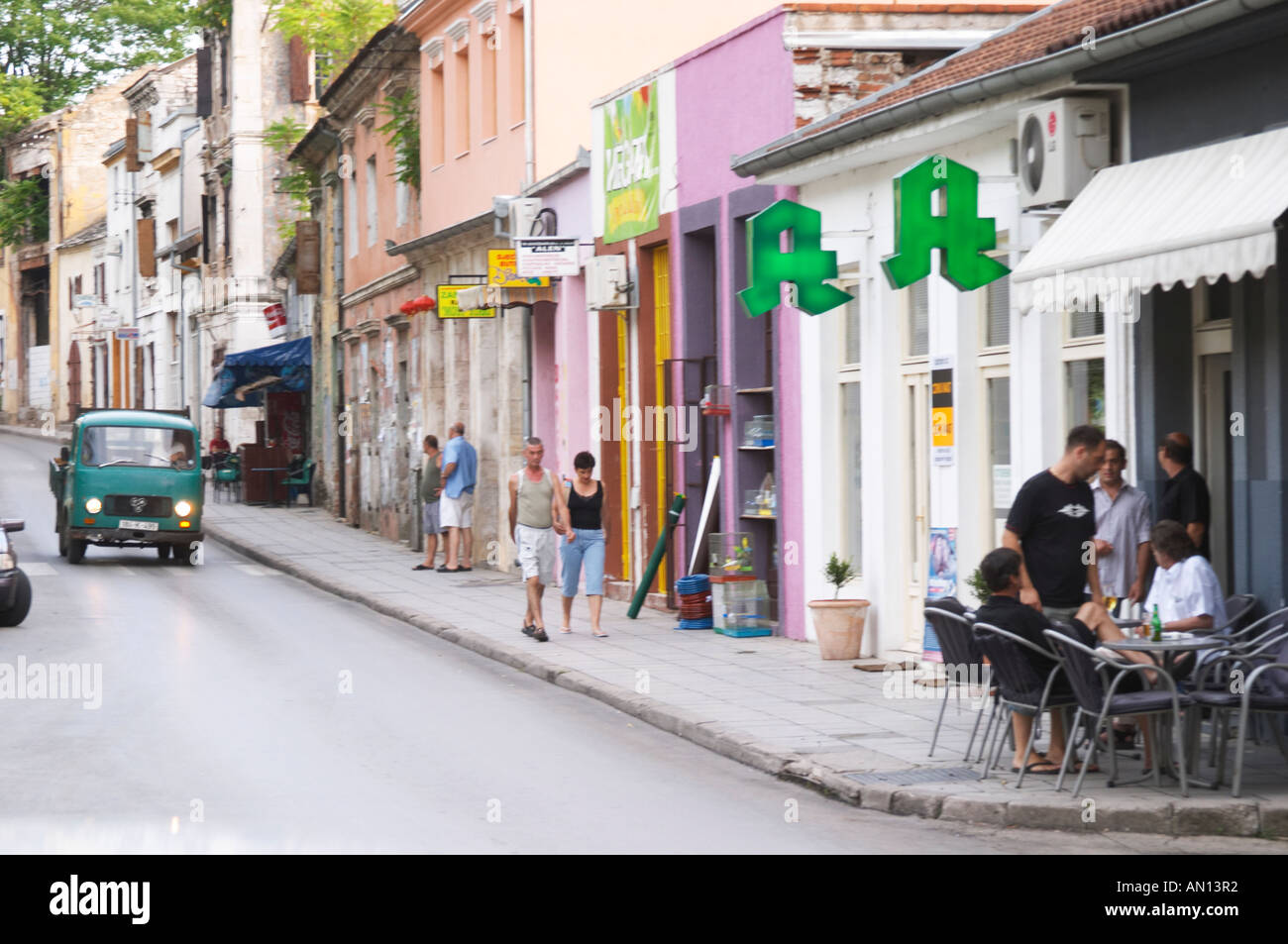 View Along Marsala Tita Tito street. Pedestrians and people sitting drinking beer at a cafe. Historic town of Mostar. Federation Bosne i Hercegovine. Bosnia Herzegovina, Europe. Stock Photo