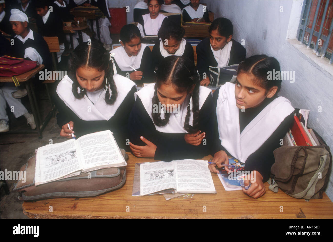 School girls and boys sitting at desks in senior secondary modern school, Punjabi University, Patiala, Punjab, India. Stock Photo