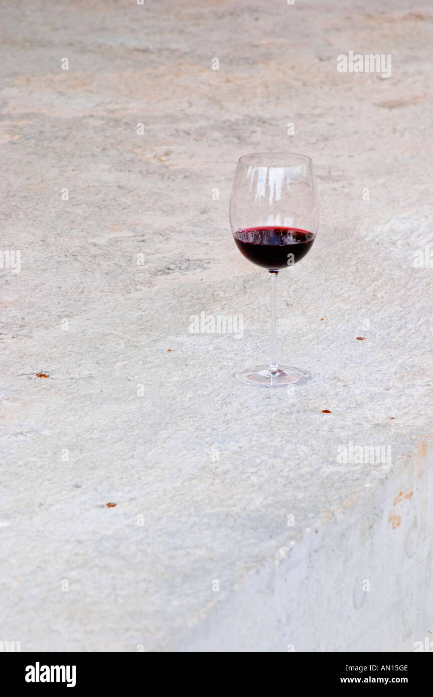 A glass of Sivric wine outside the winery. Podrum Vinoteka Sivric winery, Citluk, near Mostar. Federation Bosne i Hercegovine. Bosnia Herzegovina, Europe. Stock Photo