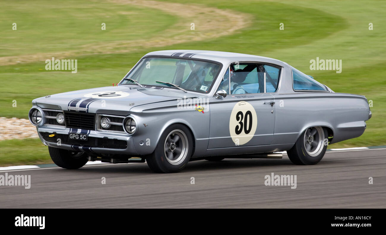 1965 Plymouth Barracuda with driver Oliver Bryant at Goodwood Revival, Sussex, UK. Stock Photo