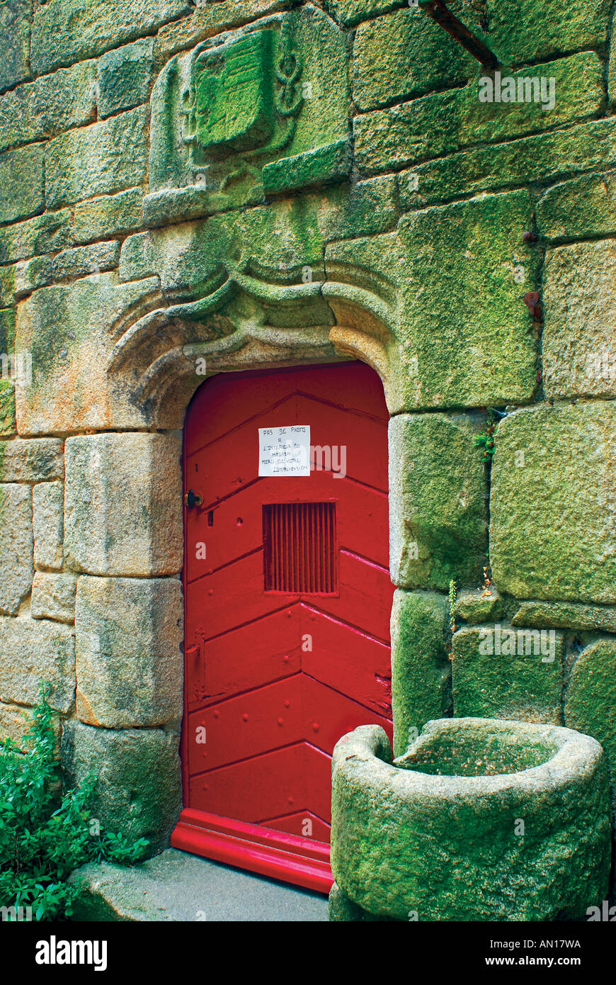 Red door of medieval stone house, Locronan, Brittany, France Stock Photo