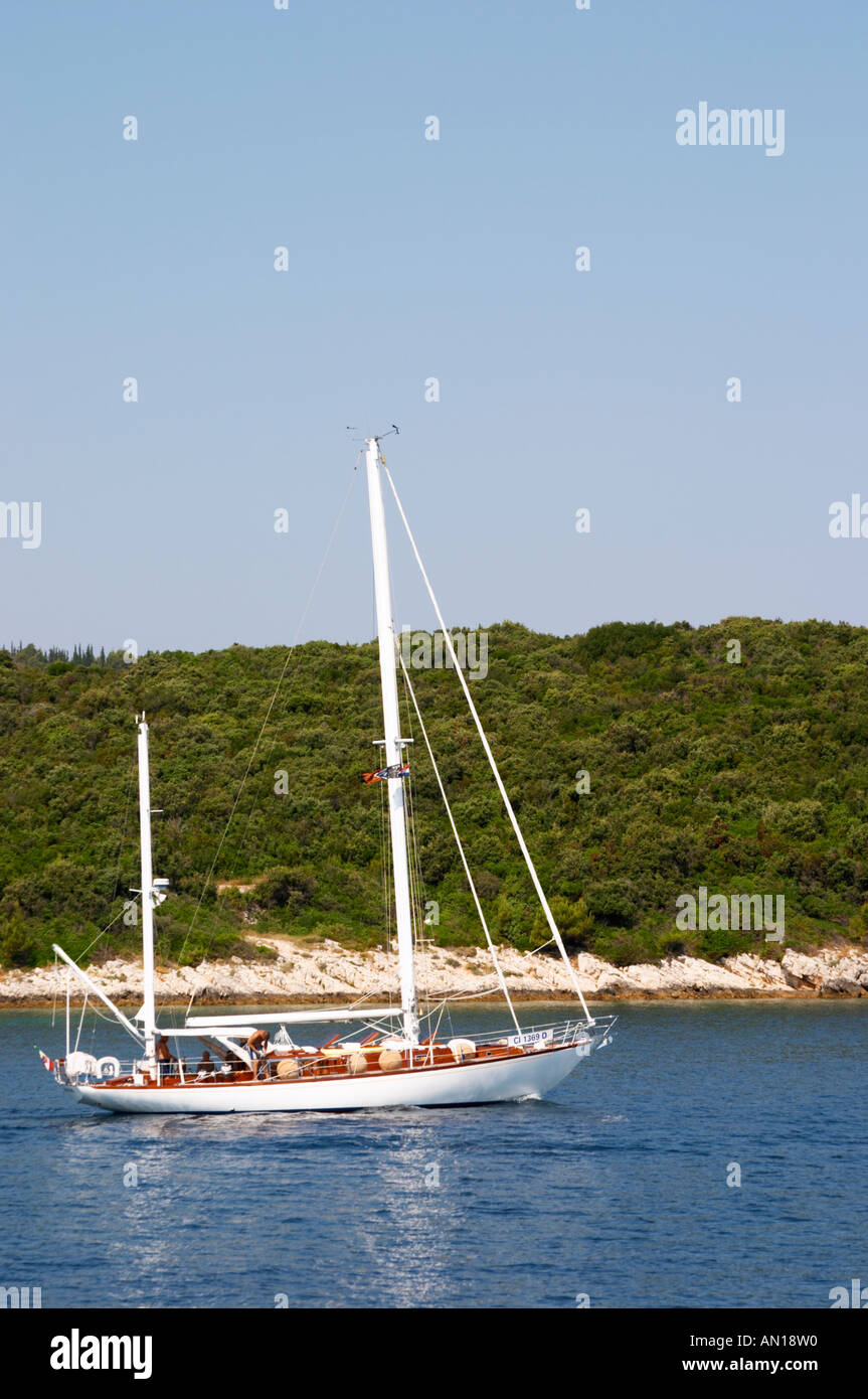 A two mast white sailing boat sailing on the deep blue sea water ...