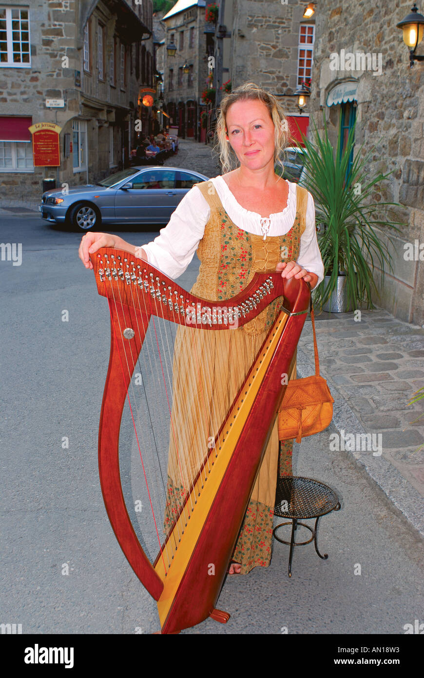 Musician Lydwen with celtic harpe, Harbour of Dinan, Brittany, France Stock Photo