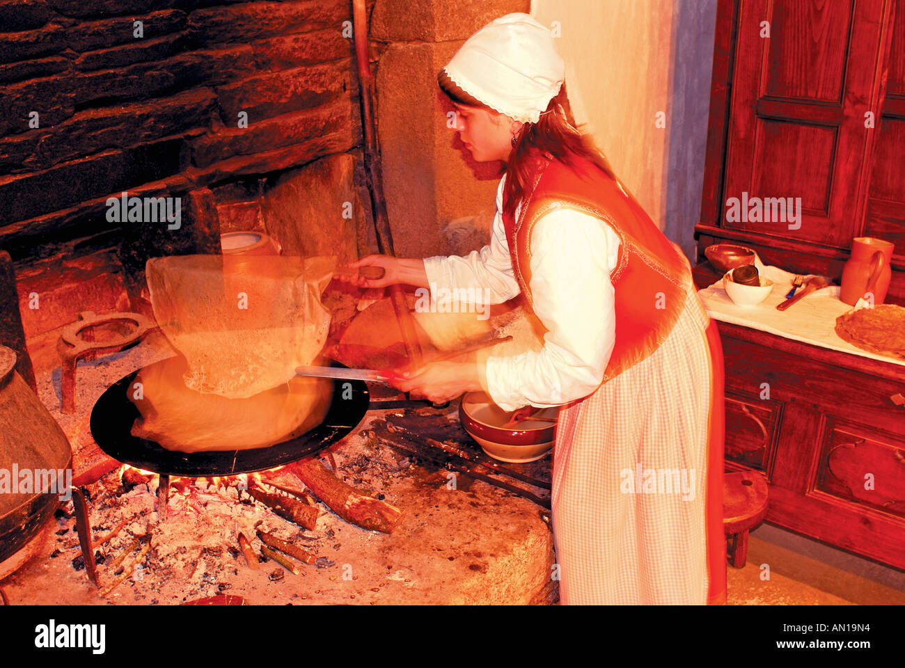 Laurille baking Crepe at Ti Louise, Museum village Poul-Fetan, Brittany, France Stock Photo