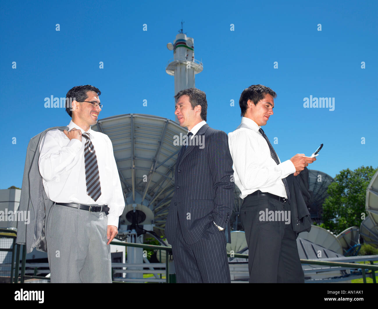 Three businessmen standing on a roof Stock Photo