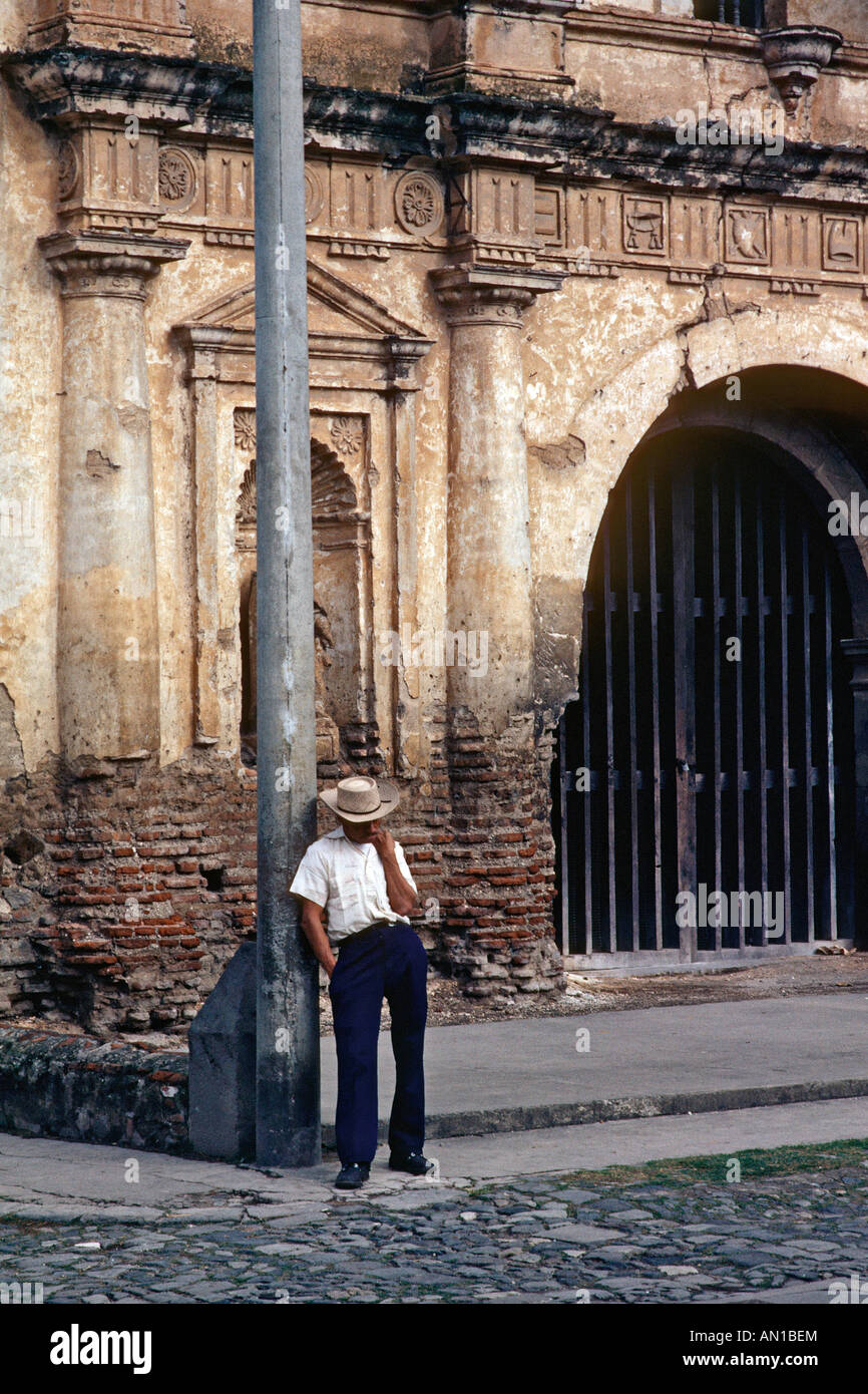 Man leaning on a lamp post in Guatemala Stock Photo - Alamy