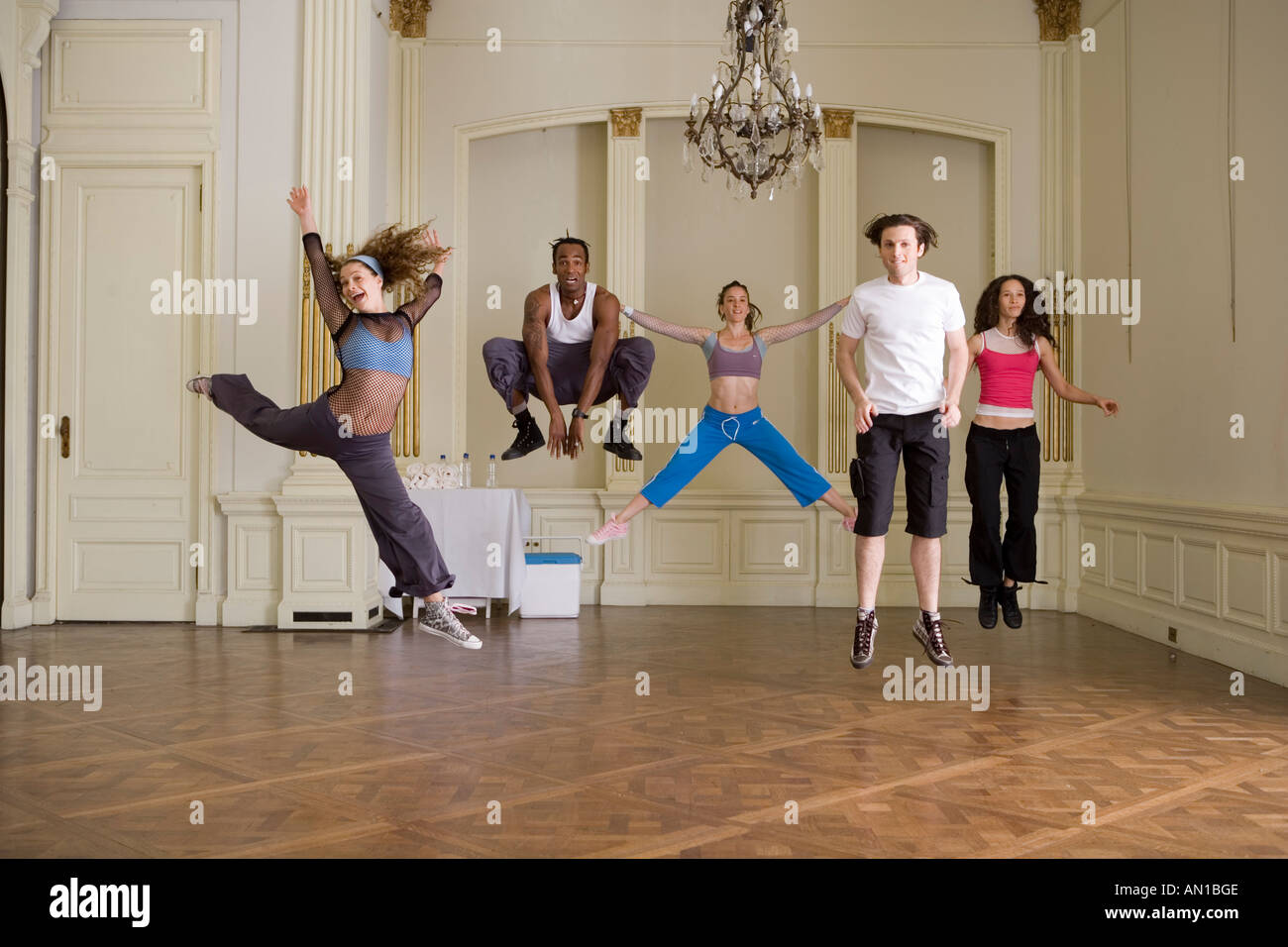 Group of people jumping in dance class Stock Photo