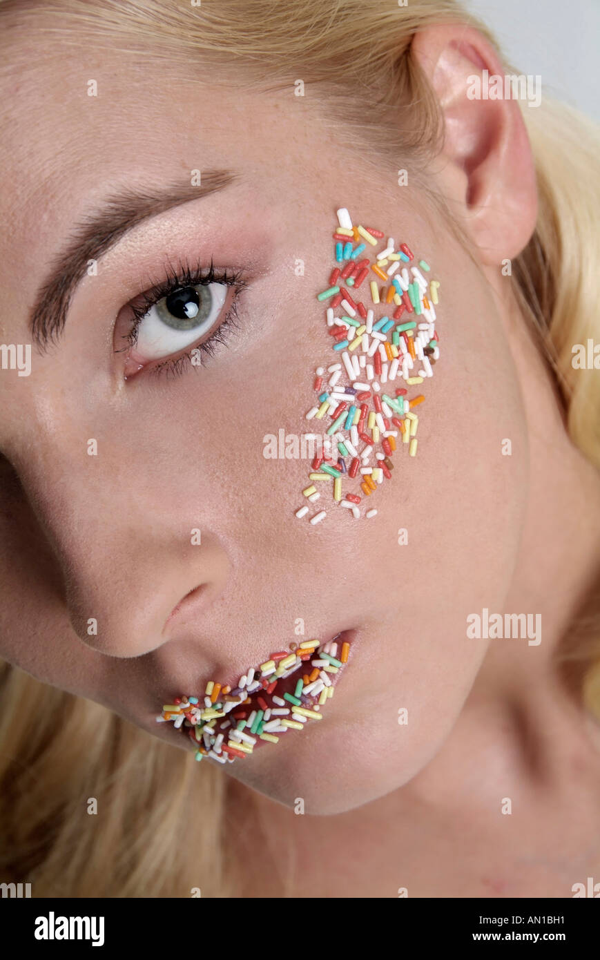 young blonde girl woman standing posing 20 with granules Stock Photo