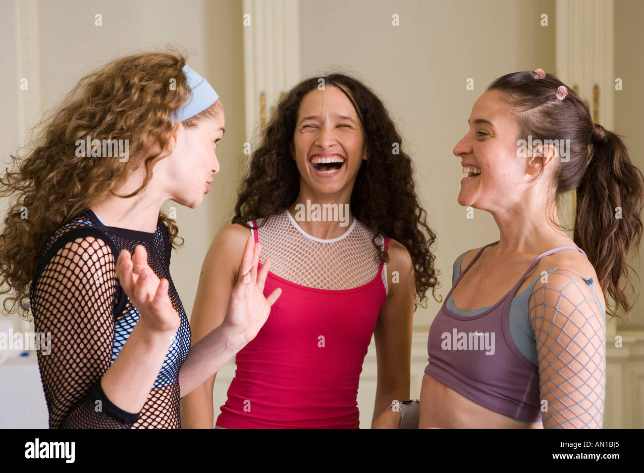 Three young women laughing together Stock Photo - Alamy