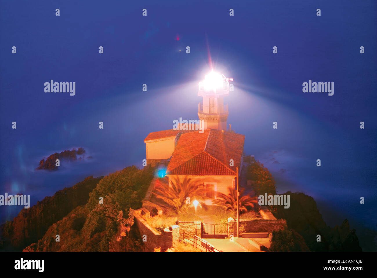 Lighthouse of Cudillero by night, Cudillero, Asturias, Spain Stock Photo