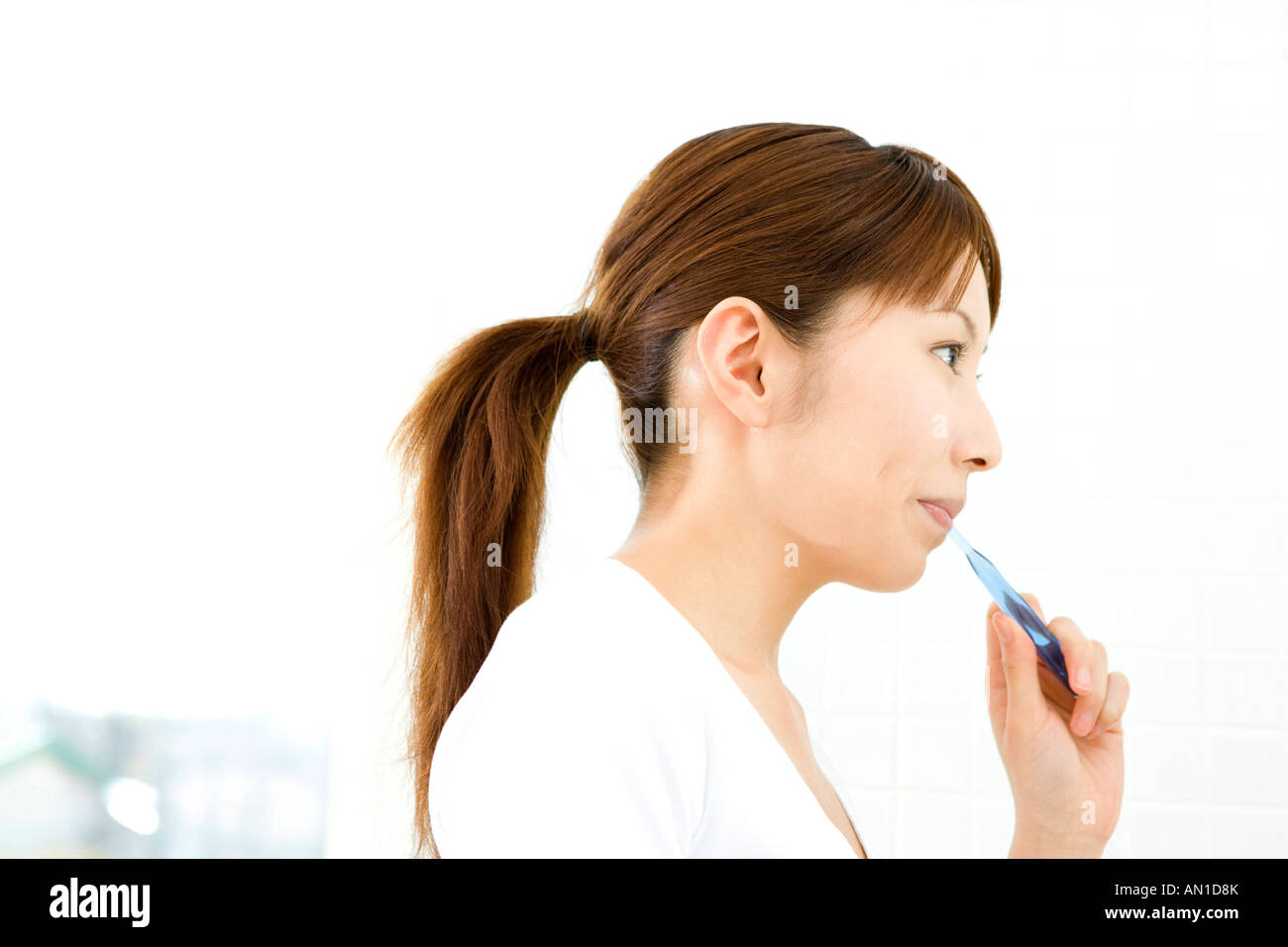 Japanese woman brushing teeth Stock Photo Alamy