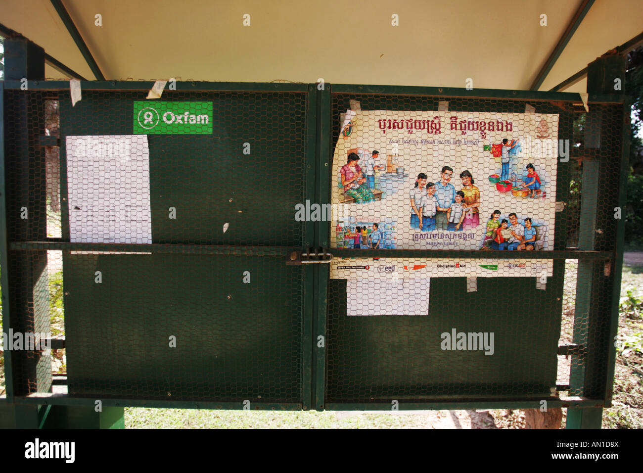 Public notice board in the village of Thmey in Cambodia. The poster deals with gender issues. Stock Photo