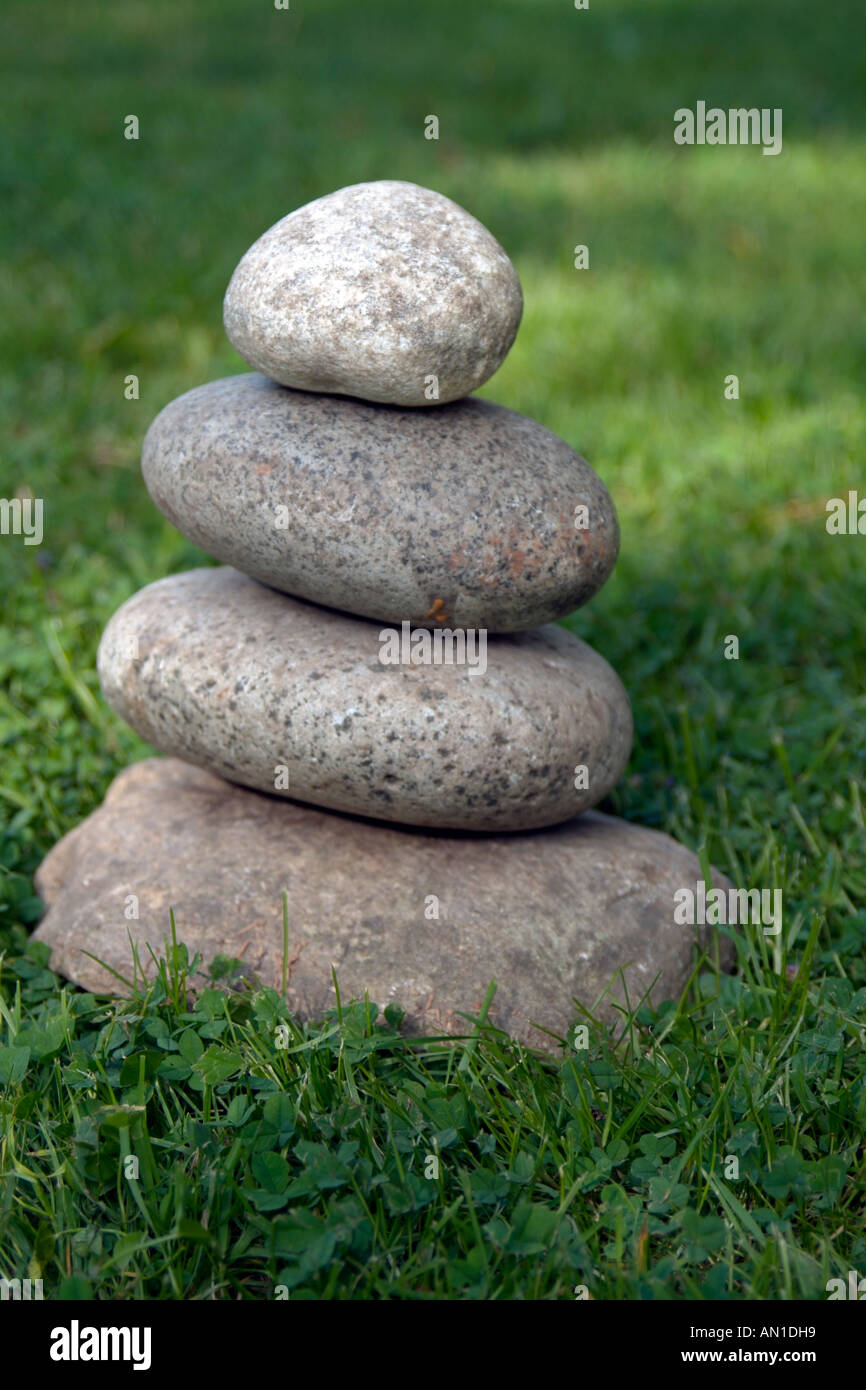 Stones well balanced well adjusted harmony Steine ZEN Buddhism Grass stack Stock Photo