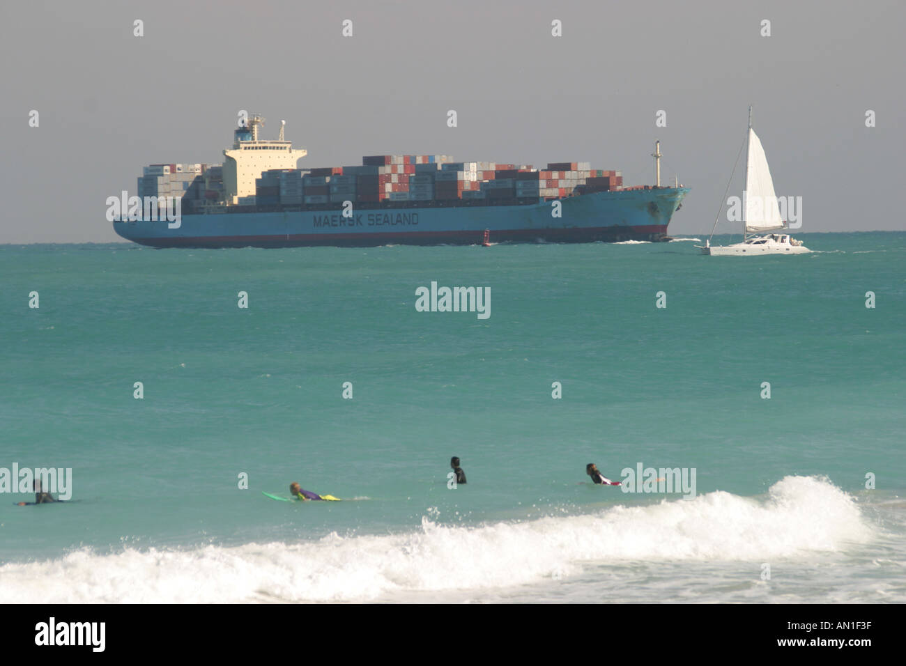 Miami Beach Florida,Atlantic Shore,shoreline,coast,coastline,seashore,cargo container ship boat approaches Port of Miami,sailboat,surfer,ocean,tide,we Stock Photo