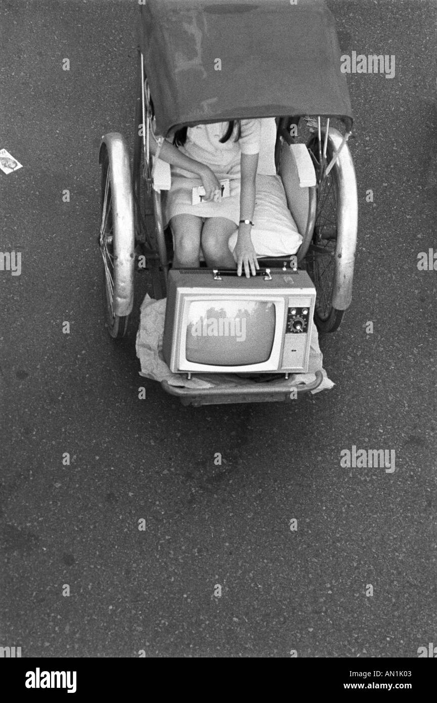 Girl moving TV Vietnam Stock Photo