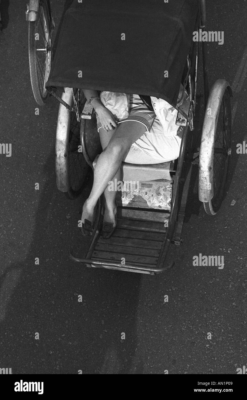 Woman passenger in pedicab seen from above Stock Photo