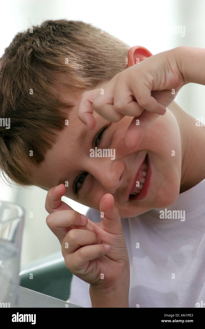 Young boy taking picture with imaginary camera Stock Photo