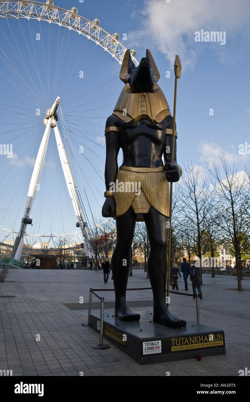 A sculpture of Anubis advertising the Tutankhamun exhibition with the London Eye in the background, London England. Stock Photo