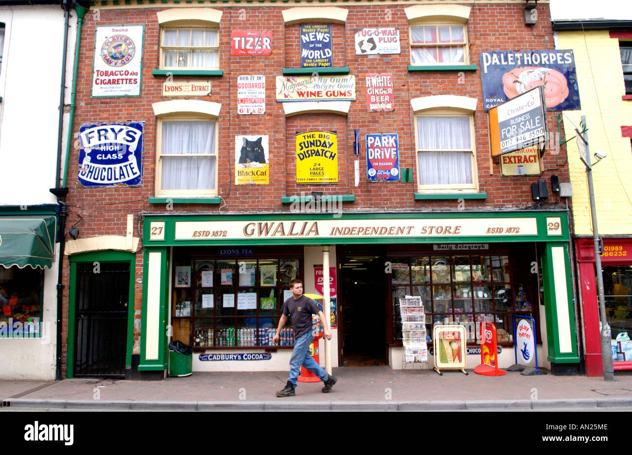 Gwalia independent store displaying old enamel advertising signs in rural market town of Ross on Wye Herefordshire England UK Stock Photo