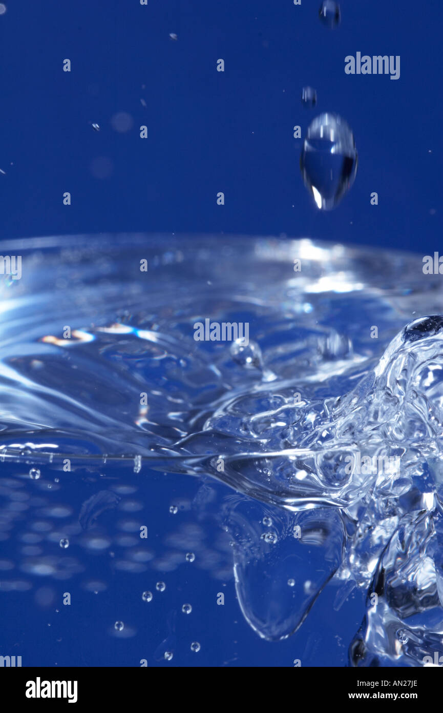 Glass sparkling water on blue background Stock Photo - Alamy