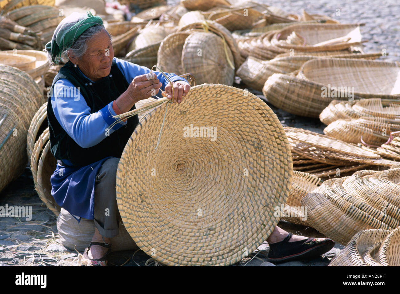 The Market / Woman making Cane Baskets, Dali, Yunnan Province, China Stock Photo