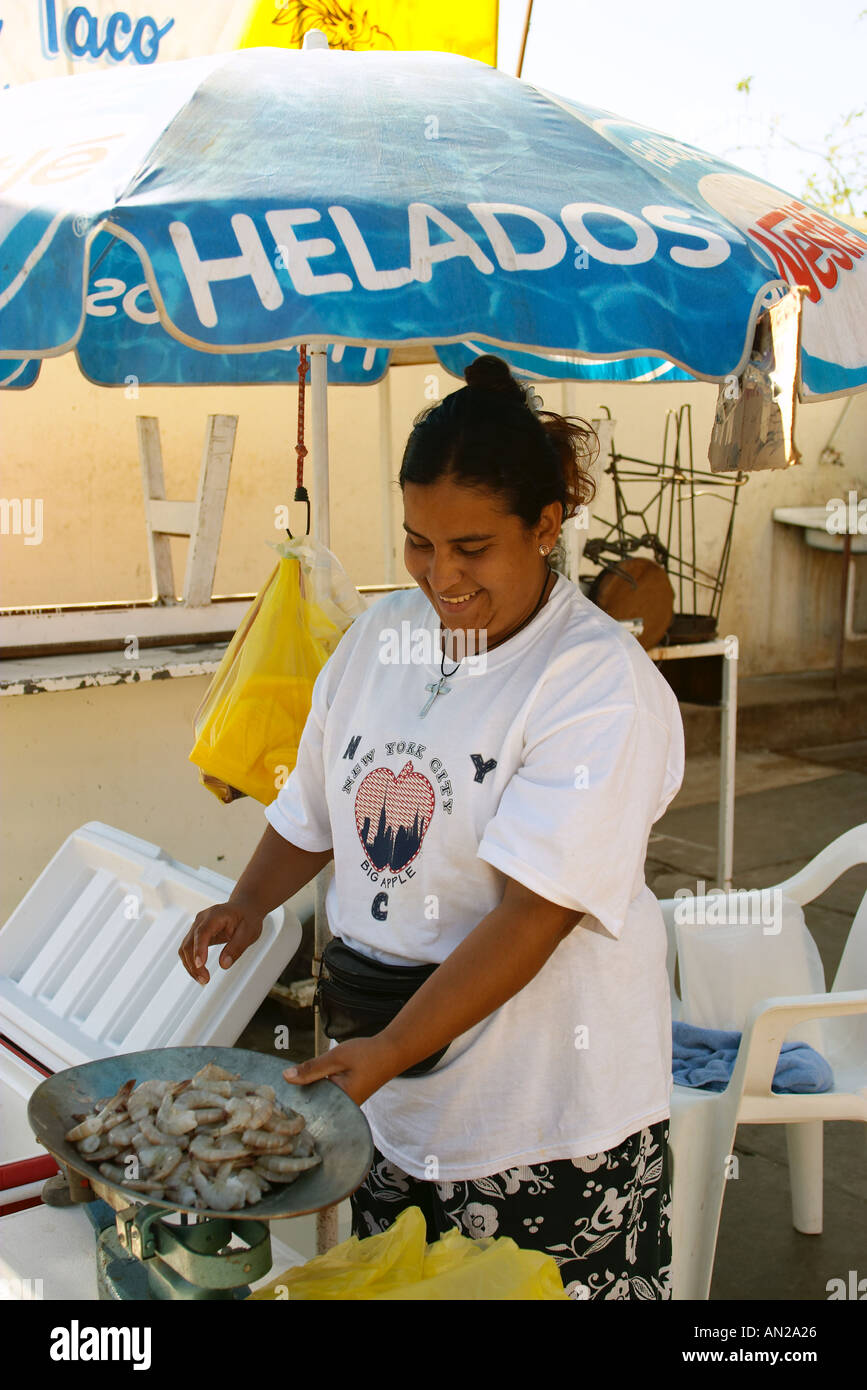MEXICO Cabo Woman sell shrimp at street stand under umbrella Stock Photo