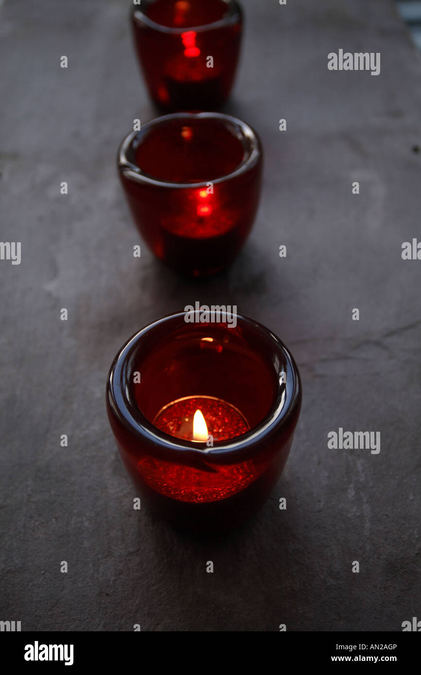 a row of red glass candle holders with glitter candles Stock Photo Alamy